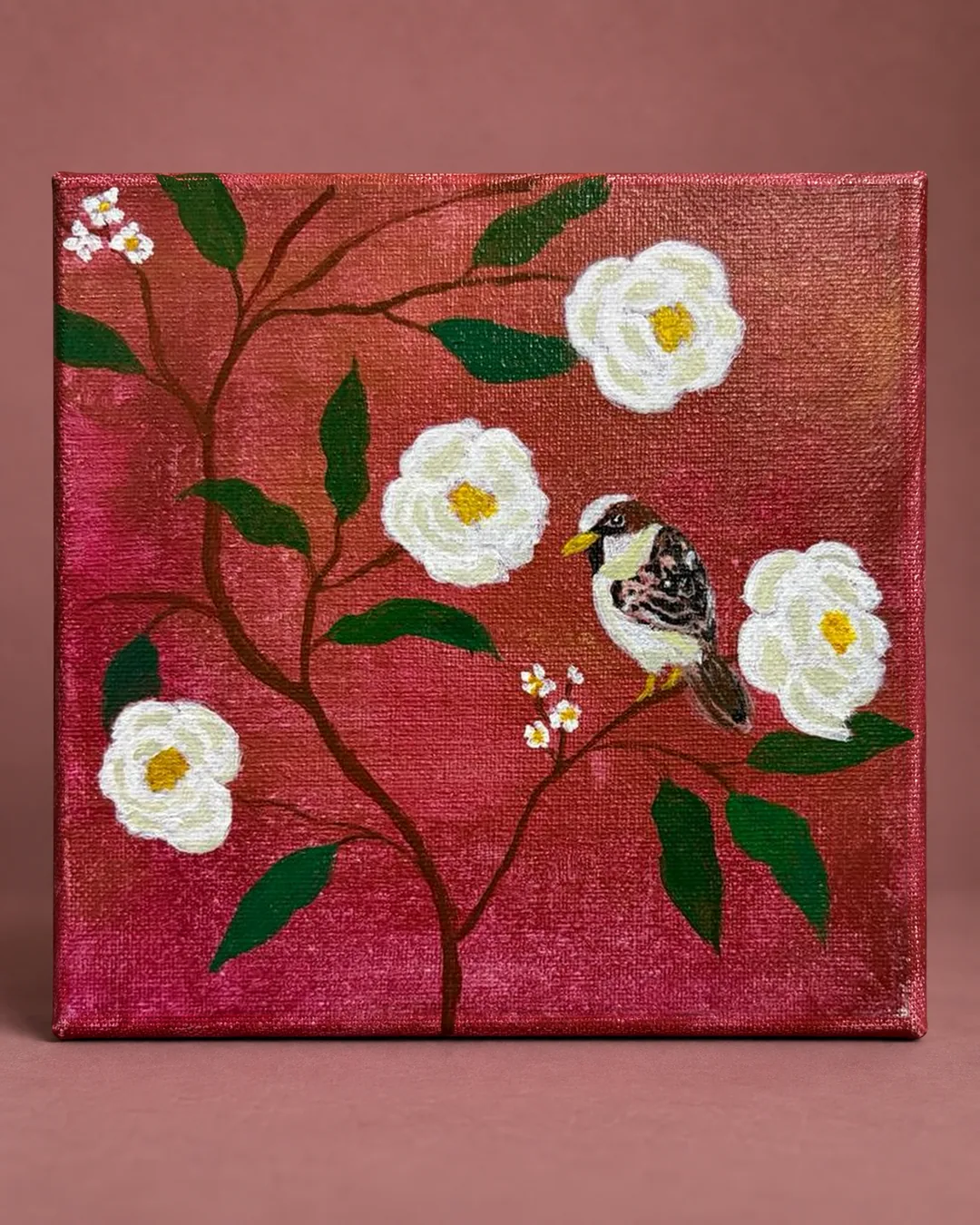 Sparrow among Camellias: a small square painting of a sparrow perched among white camellias on a deep rose ground, photographed against a dusty-rose backdrop.